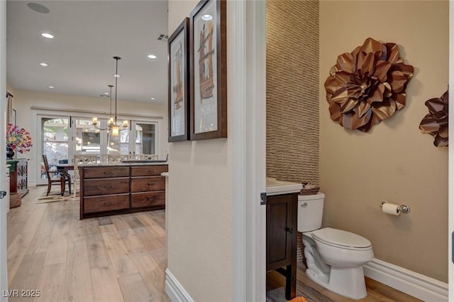 748 Puerto Real Ct, Las Vegas, NV 89138 - bathroom with vanity, wood finished floors, toilet, baseboards, and recessed lighting