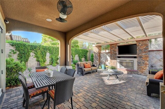 748 Puerto Real Ct, Las Vegas, NV 89138 - fenced backyard featuring a patio area, a pergola, and an outdoor living space with a fireplace