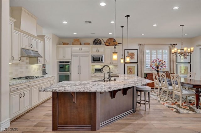 748 Puerto Real Ct, Las Vegas, NV 89138 - kitchen with built in appliances, light wood finished floors, a sink, tasteful backsplash, and recessed lighting