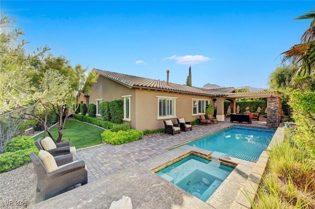 748 Puerto Real Ct, Las Vegas, NV 89138 - back of house with stucco siding, an outdoor hangout area, a patio, a pergola, and a tile roof