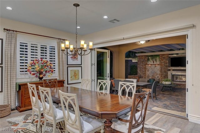 748 Puerto Real Ct, Las Vegas, NV 89138 - dining area with a chandelier, light wood-style floors, recessed lighting, and a large fireplace