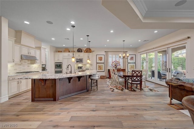 748 Puerto Real Ct, Las Vegas, NV 89138 - kitchen featuring appliances with stainless steel finishes, recessed lighting, a breakfast bar, light wood-type flooring, and decorative backsplash
