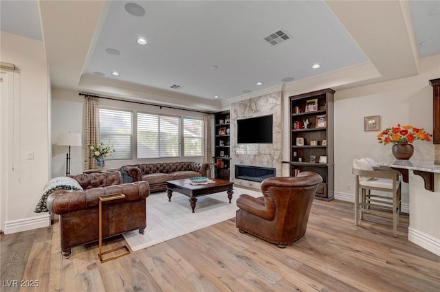 748 Puerto Real Ct, Las Vegas, NV 89138 - living area with baseboards, light wood-style floors, a high end fireplace, built in shelves, and ornamental molding