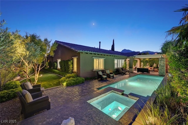 748 Puerto Real Ct, Las Vegas, NV 89138 - back of house featuring a patio, a tile roof, a pool with connected hot tub, an outdoor living space, and stucco siding