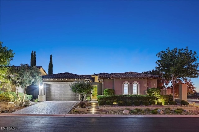 748 Puerto Real Ct, Las Vegas, NV 89138 - view of front of property featuring a garage, stucco siding, driveway, and a tiled roof