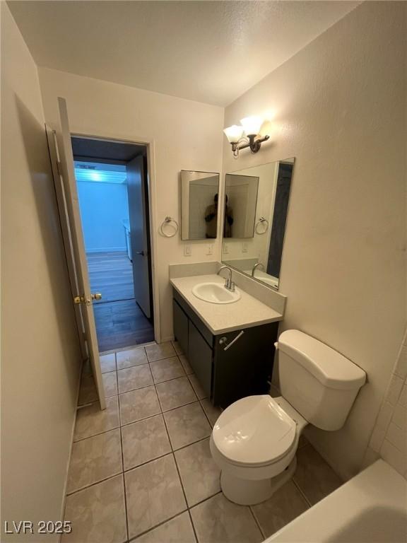 3585 Arville St Unit 403A, Las Vegas, NV 89103 - full bathroom with toilet, vanity, and tile patterned flooring