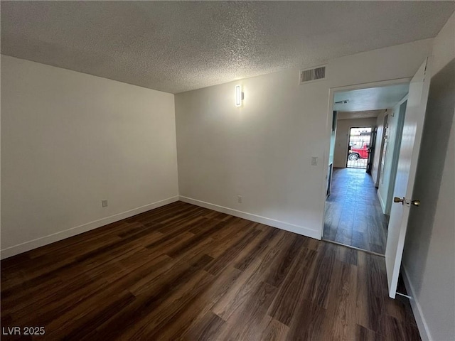 3585 Arville St Unit 403A, Las Vegas, NV 89103 - empty room featuring dark wood-style flooring, baseboards, and a textured ceiling