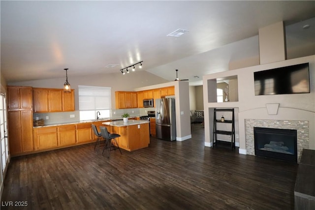 878 Samoy St, Las Vegas, NV 89110 - kitchen with stainless steel appliances, lofted ceiling, track lighting, light countertops, and open floor plan