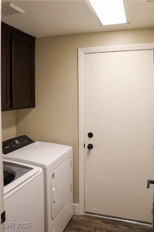 878 Samoy St, Las Vegas, NV 89110 - laundry area featuring cabinet space, separate washer and dryer, and wood finished floors