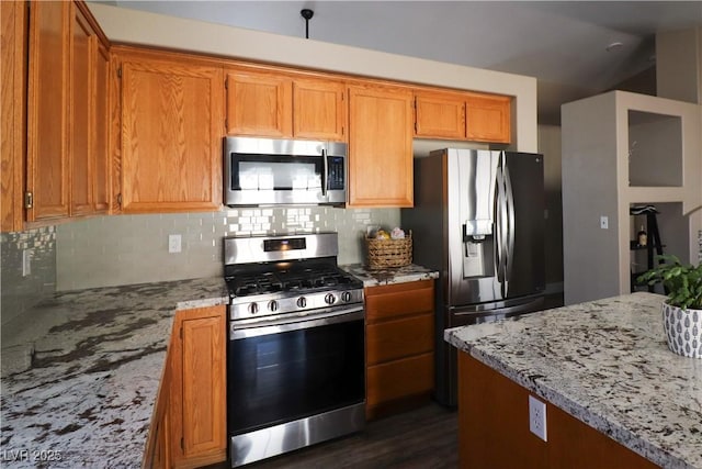 878 Samoy St, Las Vegas, NV 89110 - kitchen featuring stainless steel appliances, light stone counters, tasteful backsplash, brown cabinets, and lofted ceiling