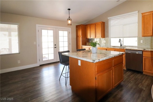 878 Samoy St, Las Vegas, NV 89110 - kitchen featuring dishwasher, backsplash, vaulted ceiling, a center island, and dark wood-style floors