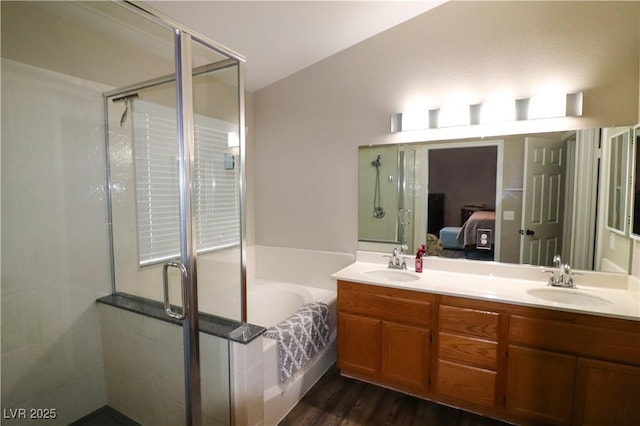 878 Samoy St, Las Vegas, NV 89110 - bathroom with a bath, double vanity, a stall shower, ensuite bath, and wood finished floors