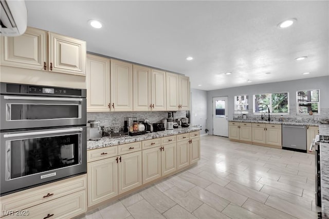 2131 Diamond Bar Dr, Las Vegas, NV 89117 - kitchen featuring cream cabinets, stainless steel appliances, backsplash, an AC wall unit, and a sink