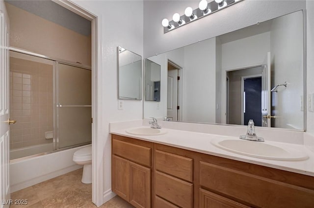 10518 Santerno St, Las Vegas, NV 89141 - bathroom featuring toilet, double vanity, and bath / shower combo with glass door