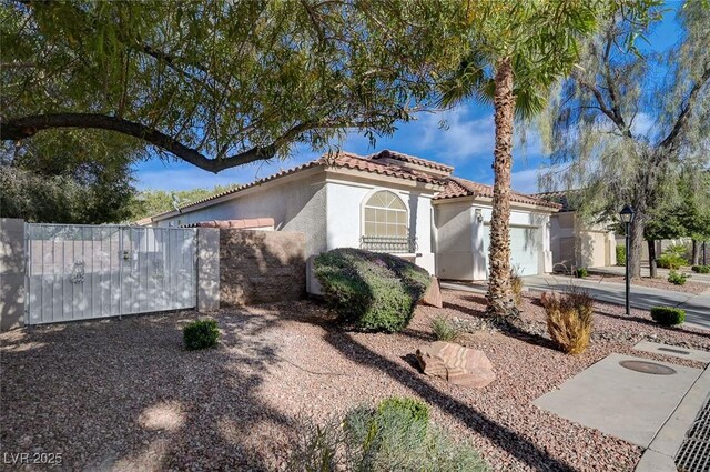 10518 Santerno St, Las Vegas, NV 89141 - view of front of home featuring stucco siding, a tiled roof, and an attached garage