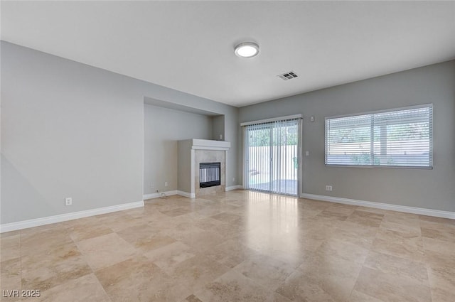 10518 Santerno St, Las Vegas, NV 89141 - unfurnished living room with a tiled fireplace and baseboards