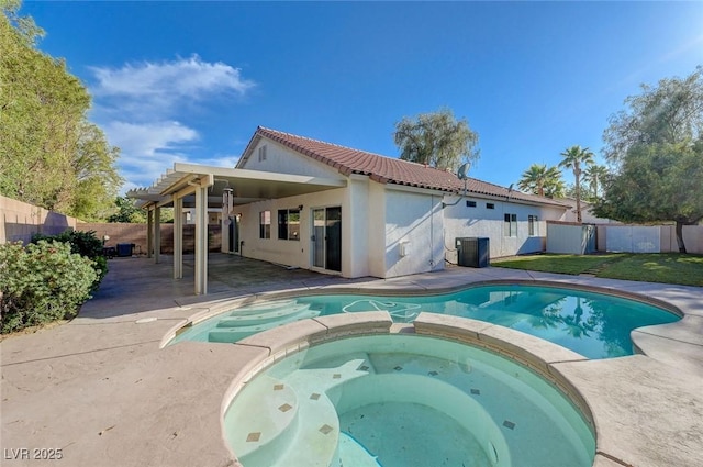10518 Santerno St, Las Vegas, NV 89141 - view of pool with central AC unit, a patio, a pool with connected hot tub, and a fenced backyard