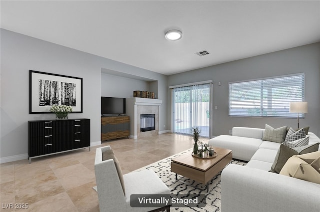 10518 Santerno St, Las Vegas, NV 89141 - living room featuring baseboards and a tiled fireplace