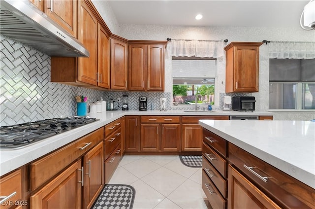 5872 Revital Ct, Las Vegas, NV 89131 - kitchen featuring under cabinet range hood, a sink, light countertops, gas cooktop, and recessed lighting