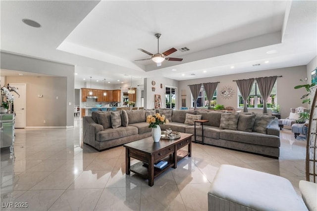 5872 Revital Ct, Las Vegas, NV 89131 - living room featuring a tray ceiling, a ceiling fan, recessed lighting, and baseboards