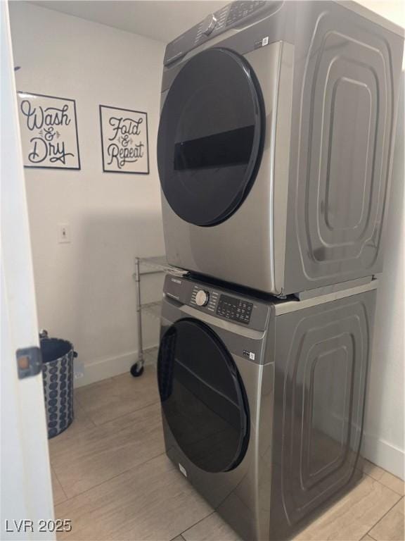 945 Vegas Valley Dr, Las Vegas, NV 89109 - washroom with stacked washing machine and dryer and baseboards