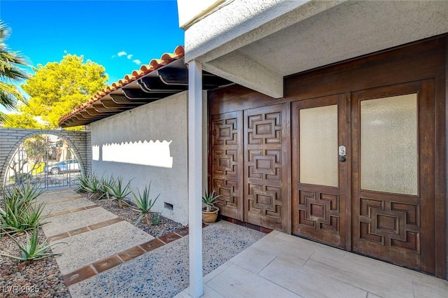 945 Vegas Valley Dr, Las Vegas, NV 89109 - property entrance featuring a patio, a tile roof, and stucco siding