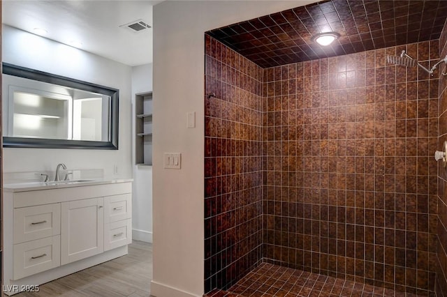 945 Vegas Valley Dr, Las Vegas, NV 89109 - full bath featuring tiled shower, vanity, and wood finished floors