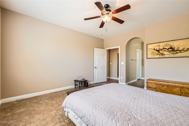 10121 Iron Wood Peak Ave, Las Vegas, NV 89166 - bedroom with arched walkways, baseboards, and a ceiling fan