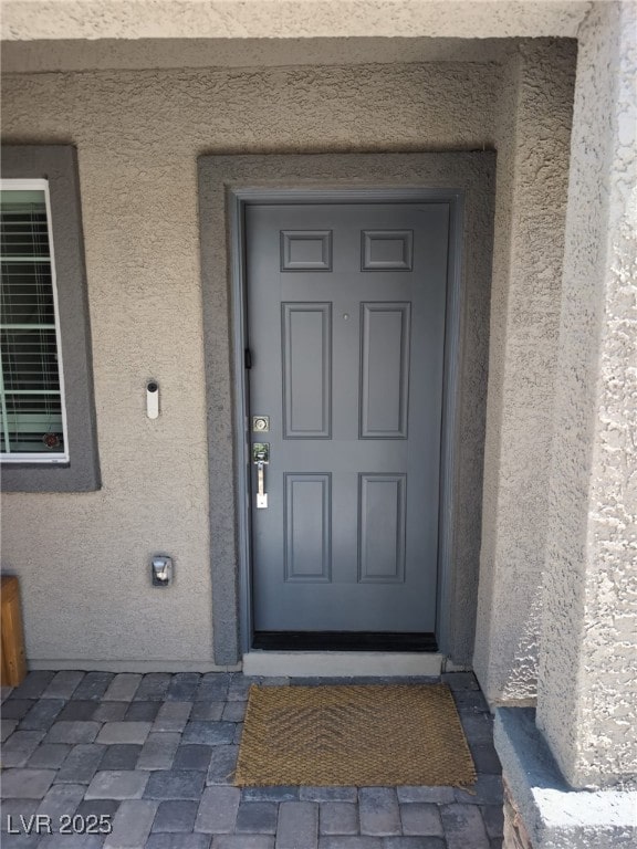 5669 Steampunk St, Las Vegas, NV 89118 - entrance to property with stucco siding