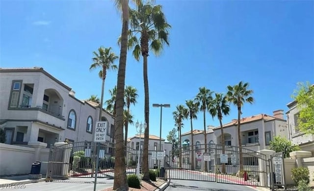 3125 N Buffalo Dr Unit 2104, Las Vegas, NV 89128 - view of asphalt street featuring a gate, a gated entry, curbs, and a residential view