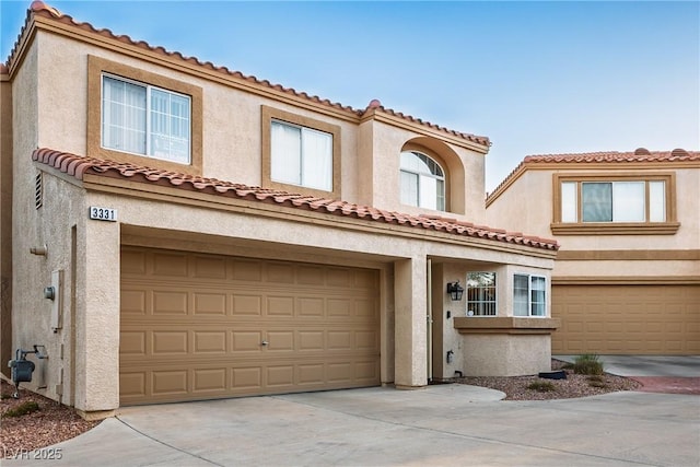 3331 Cheltenham St, Las Vegas, NV 89129 - view of front of house featuring driveway, a garage, stucco siding, and a tile roof