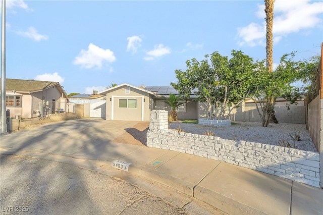 5453 Yvonne Cir, Las Vegas, NV 89122 - ranch-style house with a gate, roof mounted solar panels, concrete driveway, stucco siding, and a residential view