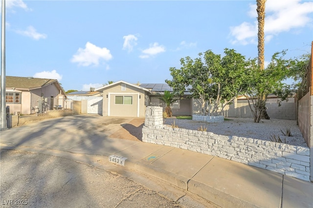 5453 Yvonne Cir, Las Vegas, NV 89122 - single story home with a gate, solar panels, concrete driveway, stucco siding, and a residential view