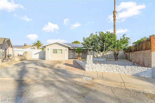 5453 Yvonne Cir, Las Vegas, NV 89122 - single story home featuring a gate, roof mounted solar panels, and stucco siding