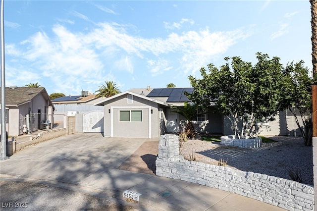 5453 Yvonne Cir, Las Vegas, NV 89122 - ranch-style home with a gate, solar panels, stucco siding, and driveway