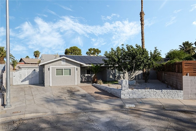 5453 Yvonne Cir, Las Vegas, NV 89122 - view of front of house featuring a gate, solar panels, and stucco siding