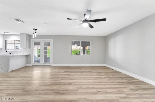 5453 Yvonne Cir, Las Vegas, NV 89122 - unfurnished living room with light wood finished floors and a ceiling fan