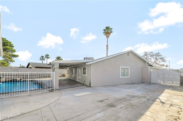 5453 Yvonne Cir, Las Vegas, NV 89122 - rear view of property featuring a gate, stucco siding, and a patio area