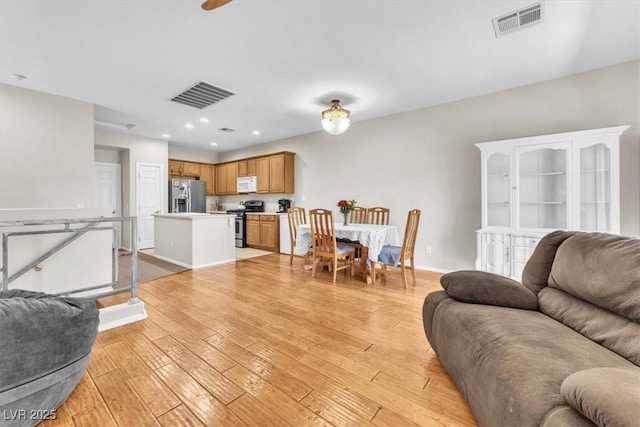 7852 Running Doe Ct, Las Vegas, NV 89149 - living room with light wood finished floors, recessed lighting, and baseboards