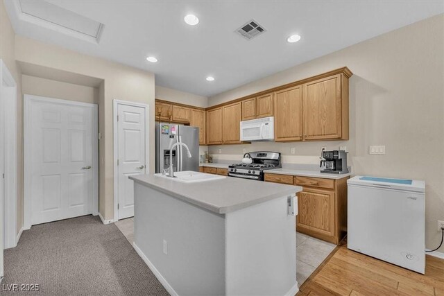 7852 Running Doe Ct, Las Vegas, NV 89149 - kitchen featuring appliances with stainless steel finishes, light countertops, an island with sink, a sink, and recessed lighting