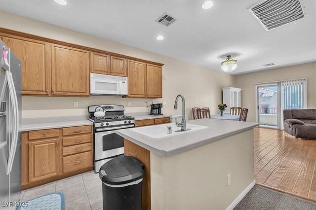 7852 Running Doe Ct, Las Vegas, NV 89149 - kitchen featuring appliances with stainless steel finishes, a sink, open floor plan, light countertops, and recessed lighting