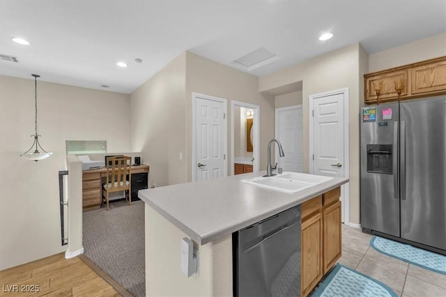 7852 Running Doe Ct, Las Vegas, NV 89149 - kitchen with appliances with stainless steel finishes, a sink, light countertops, a center island with sink, and hanging light fixtures