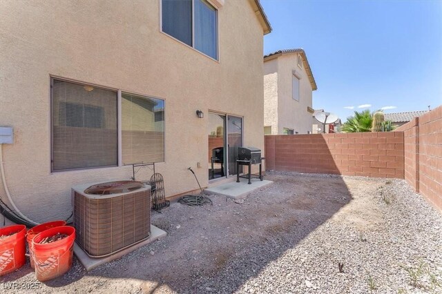 7852 Running Doe Ct, Las Vegas, NV 89149 - rear view of house featuring stucco siding, central AC unit, and a fenced backyard