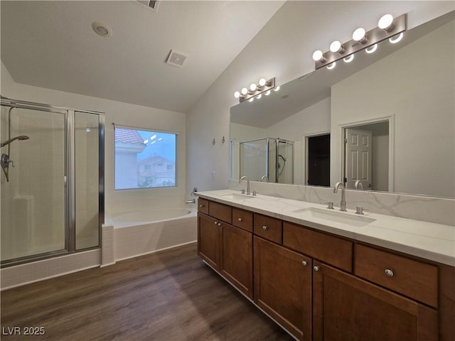 6638 Babys Tear Pl, Las Vegas, NV 89148 - full bath featuring lofted ceiling, a garden tub, a shower stall, wood finished floors, and double vanity