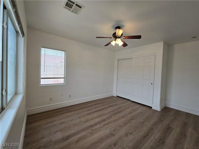 6638 Babys Tear Pl, Las Vegas, NV 89148 - unfurnished bedroom with dark wood-style floors, a closet, baseboards, and a ceiling fan