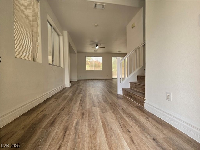 6638 Babys Tear Pl, Las Vegas, NV 89148 - unfurnished living room with wood finished floors, ceiling fan, stairway, and baseboards