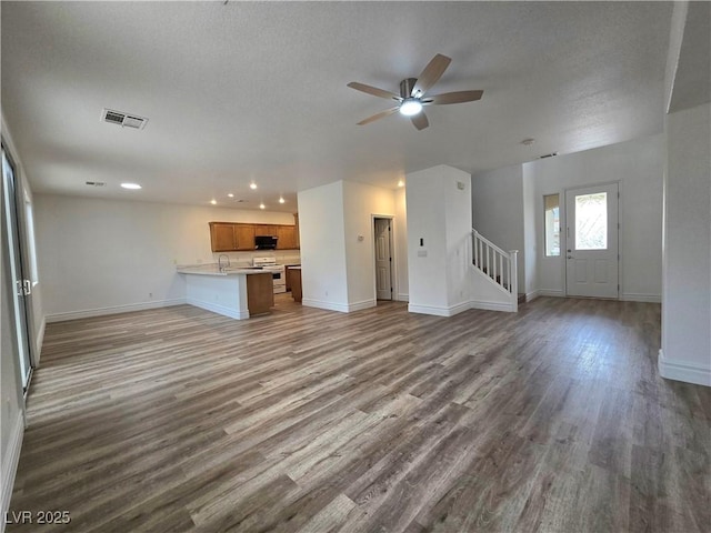 6638 Babys Tear Pl, Las Vegas, NV 89148 - unfurnished living room with stairway, recessed lighting, baseboards, a ceiling fan, and wood finished floors