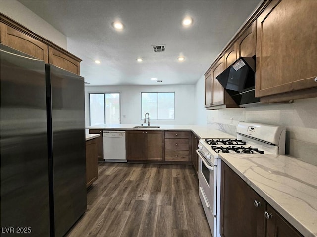 6638 Babys Tear Pl, Las Vegas, NV 89148 - kitchen with white appliances, a sink, recessed lighting, dark wood finished floors, and ventilation hood