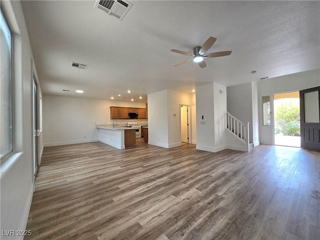 6638 Babys Tear Pl, Las Vegas, NV 89148 - unfurnished living room with recessed lighting, baseboards, wood finished floors, and stairway