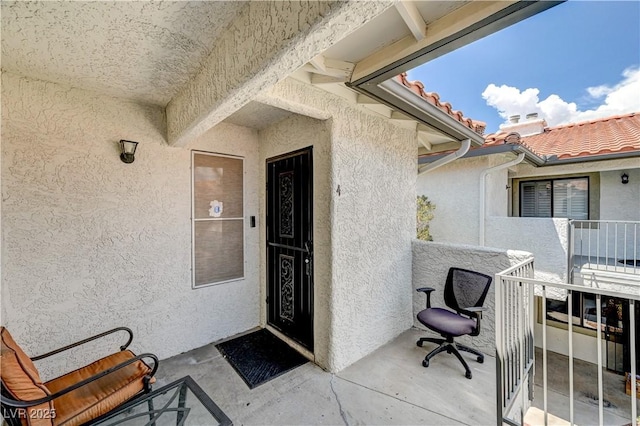 6735 W Charleston Blvd Unit 4, Las Vegas, NV 89146 - property entrance with stucco siding, a balcony, and a tile roof